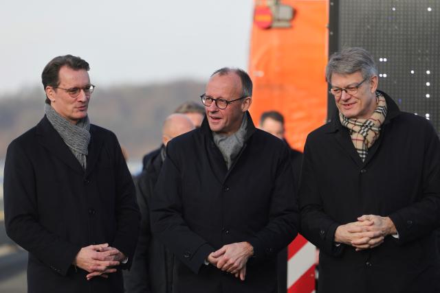 22 December 2025, North Rhine-Westphalia, Lüdenscheid: Hendrik Wuest (L-R), Minister President of North Rhine-Westphalia, German Chancellor Friedrich Merz and German Transport Minister Patrick Schnieder at the opening of the Rahmedetal Bridge. The important A45 north-south axis in the Sauerland region was interrupted for almost four years due to a dilapidated bridge. The dilapidated bridge was closed at the beginning of December 2021 and later blown up. Photo: Rolf Vennenbernd/dpa