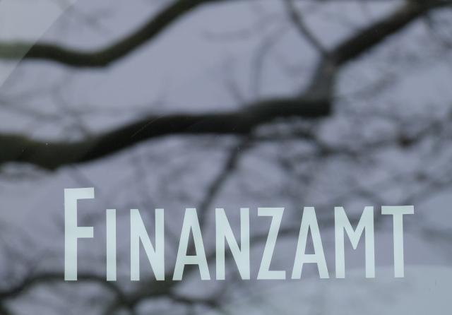 FILED - 18 March 2024, Baden-Württemberg, Stuttgart: The lettering "Finanzamt" is attached to a pane at the entrance to the tax office in Stuttgart. The branches of a treetop are reflected in the pane. Photo: Bernd Weißbrod/dpa