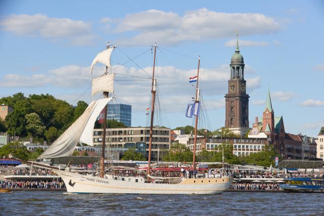 FILED - 12 May 2024, Hamburg: The sailing ship "Mare Frisium" glides across the Elbe during the Hamburg Harbor Birthday, with the Landungsbruecken and the "Michel" visible in the background. A fire broke out on board the historic sailing ship Mare Frisium in the German port city of Hamburg, authorities said early on Thursday. Photo: Georg Wendt/dpa