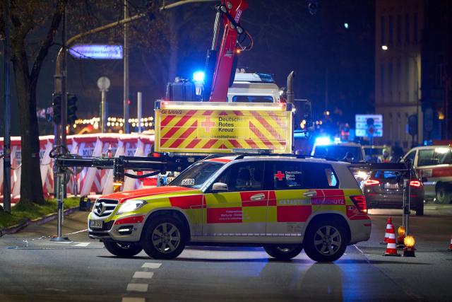 FILED - 22 December 2025, Hesse, Giessen: Emergency vehicles from the German Red Cross are parked in the center of Giessen, where a car is said to have driven into a bus stop and three people are injured. Photo: Sascha Ditscher/dpa
