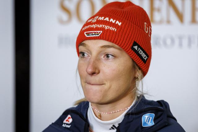 27 December 2025, Bavaria, Fischen Im Allgaeu: German ski jumper Katharina Schmid speaks at a press event before the Four Hills Tournament. The 29-year-old announced at the event that she would be ending her active career after this winter. Photo: Daniel Karmann/dpa