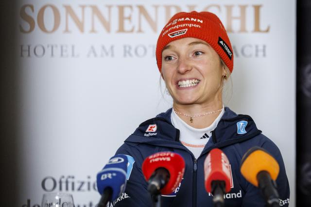 27 December 2025, Bavaria, Fischen Im Allgaeu: German ski jumper Katharina Schmid speaks at a press event before the Four Hills Tournament. The 29-year-old announced at the event that she would be ending her active career after this winter. Photo: Daniel Karmann/dpa