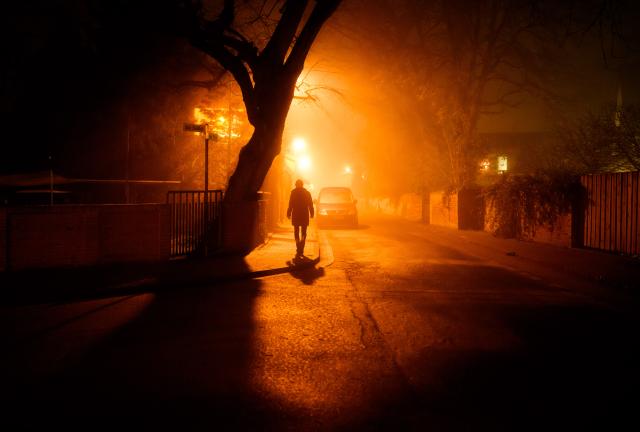 28 December 2025, Lower Saxony, Laatzen: A woman walks across an icy road in the Hanover region amid fog and sub-zero temperatures. Fog, frost, and freezing rain once again make the roads slippery. Photo: Julian Stratenschulte/dpa