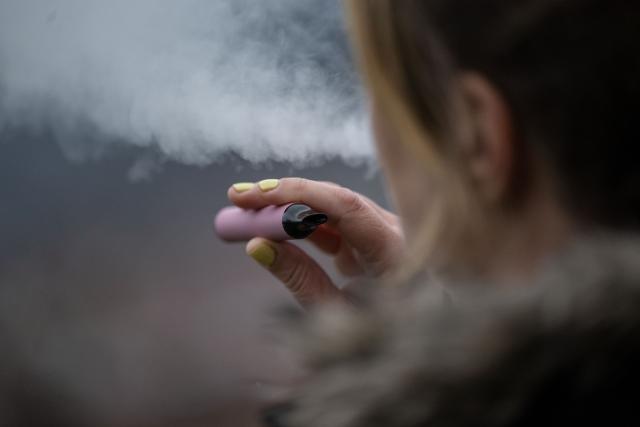 FILED - 26 January 2023, Stuttgart: A woman uses an e-cigarette. Photo: Marijan Murat/dpa