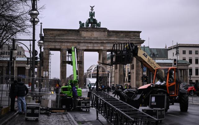 29 December 2025, Berlin: Workers set up installations at the Brandenburg Gate during preparations for the New Year's Eve event in Berlin. Due to the planned celebrations, parts of Strasse des 17. Juni are closed. Photo: Britta Pedersen/dpa