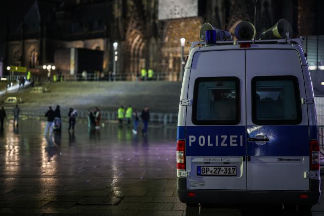 31 December 2025, North Rhine-Westphalia, Cologne: A Police vehicle parks on the square between Cologne Central Station and Cologne Cathedral. Photo: Christoph Reichwein/dpa