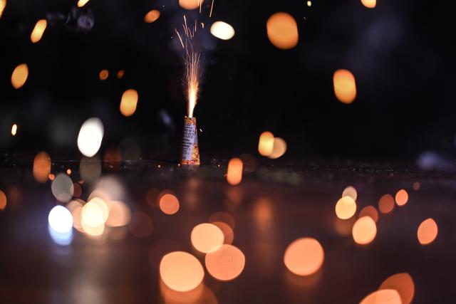31 December 2025, Lower Saxony, Leer: A family lights sparklers together. Photo: Lars Penning/dpa