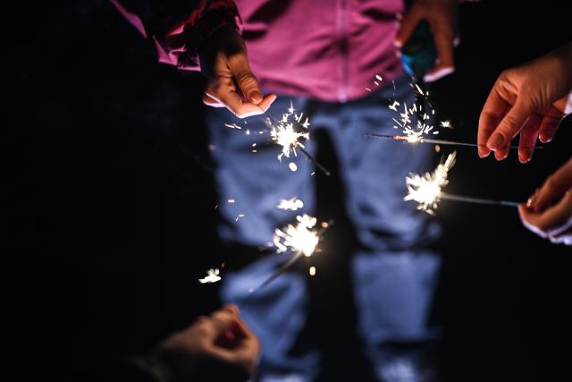 31 December 2025, Lower Saxony, Leer: A firework volcano burns on a sidewalk. Photo: Lars Penning/dpa