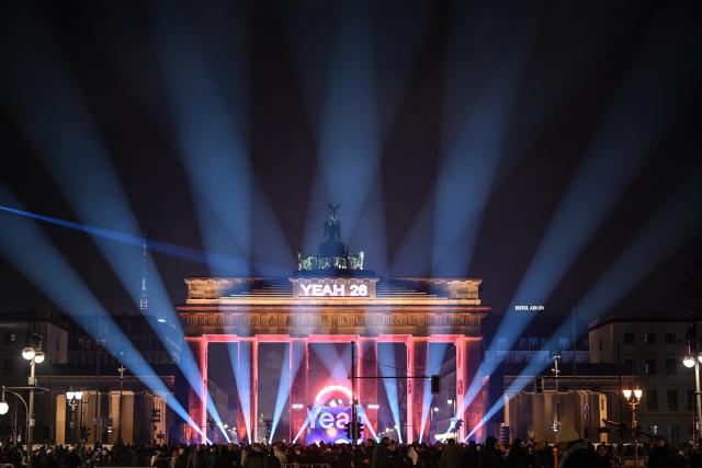 31 December 2025, Berlin: Lasers light up the sky in front of the Brandenburg Gate during the "WeAreBerlin" party. Photo: Britta Pedersen/dpa