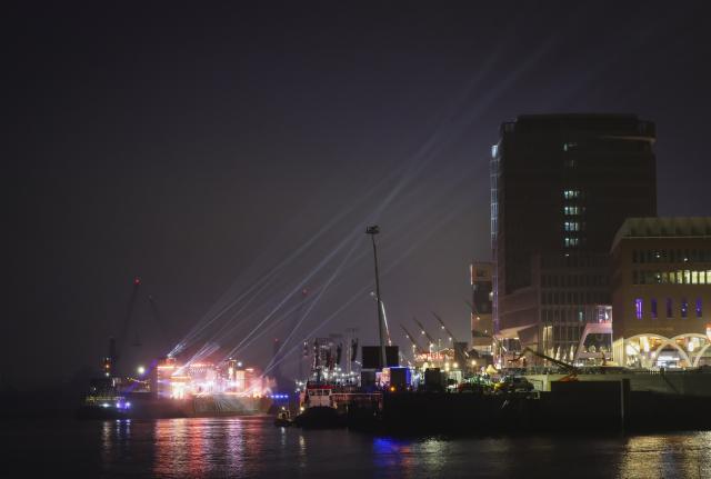 31 December 2025, Hamburg: The floating stage for the ZDF New Year's Eve show is set up on the Chicagokai in front of the Westfield Hamburg Ueberseequartier in HafenCity. The ZDF New Year's Eve show is taking place in Hamburg's HafenCity for the first time. Photo: Christian Charisius/dpa