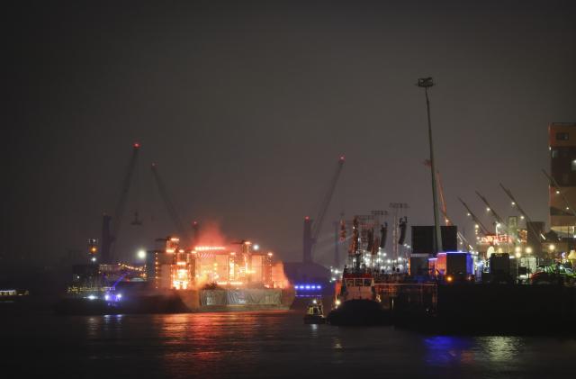 31 December 2025, Hamburg: The floating stage for the ZDF New Year's Eve show is set up on the Chicagokai in front of the Westfield Hamburg Ueberseequartier in HafenCity. The ZDF New Year's Eve show is taking place in Hamburg's HafenCity for the first time. Photo: Christian Charisius/dpa