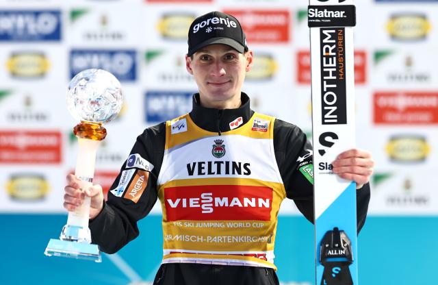 01 January 2026, Bavaria, Garmisch-Partenkirchen: Winner Slovenia's Domen Prevc celebrates on the podium after the Men's large hill 2nd round of the Four Hills Tournament in the World Cup. Photo: Daniel Karmann/dpa