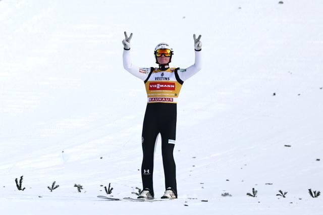 01 January 2026, Bavaria, Garmisch-Partenkirchen: Winner Slovenia's Domen Prevc celebrates at the finish line after the Men's large hill 2nd round of the Four Hills Tournament in the World Cup. Photo: Daniel Karmann/dpa
