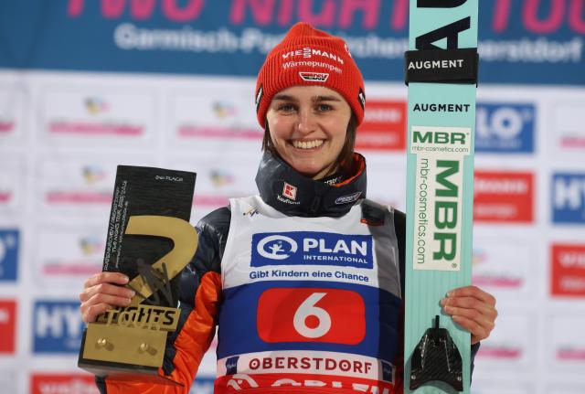 01 January 2026, Bavaria, Oberstdorf: Second-placed Germany's Selina Freitag stands on the podium during the overall winners' ceremony of the women's large hill event at the Two-Nights Tour World Cup. Photo: Karl-Josef Hildenbrand/dpa