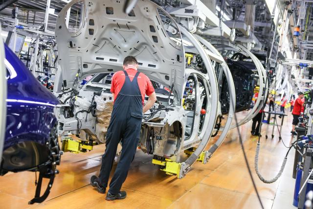 FILED - 11 March 2024, Saxony, Leipzig: An employee assembles a Porsche Macan at the Leipzig plant. The number of employed people in Germany failed to rise last year for the first time since the coronavirus pandemic, official figures showed on Friday. Photo: Jan Woitas/dpa
