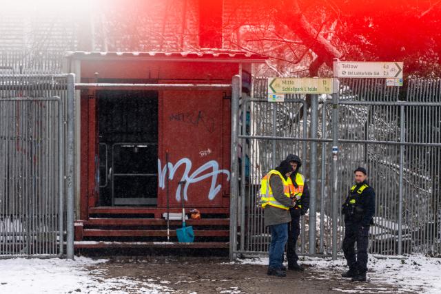 03 January 2026, Berlin: Police officers stand at the site of a cable bridge fire in front of the Lichterfelde power station on the Teltow Canal. After a cable bridge caught fire, 50,000 households and 2,000 businesses in south-west Berlin lost power. Photo: Michael Kappeler/dpa