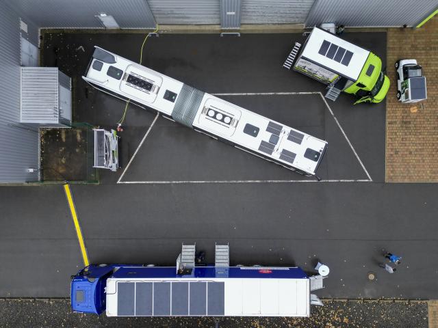 FILED - 23 October 2025, Saxony, Zwenkau: A regional bus equipped with solar modules, a truck with a semi-trailer and two vans stand as application examples in front of the new Opes Solar Mobility GmbH factory for the production of photovoltaic modules for vehicles. Photo: Jan Woitas/dpa