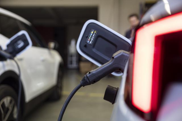 FILED - 15 October 2025, Rhineland-Palatinate, Mainz: A charging plug is plugged into a car in a hall belonging to the company Ambibox. Photo: Hannes P Albert/dpa