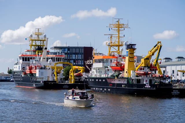 FILED - 03 July 2025, Bremen, Bremerhaven: The ships "Atair" (L) and "Wega" are moored at a quay wall. The two ships are used as survey, wreck search and research vessels by the Federal Maritime and Hydrographic Agency (BSH). The warming of both the North and Baltic seas in continuing, with the North Sea posting a 56-year record, according to figures released by BSH. Photo: Hauke-Christian Dittrich/dpa