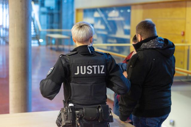 09 January 2026, Thuringia, Meiningen: Right-wing extremist Tommy Frenck (r) is searched before his trial for tax evasion in Meiningen district court. Photo: Michael Reichel/dpa