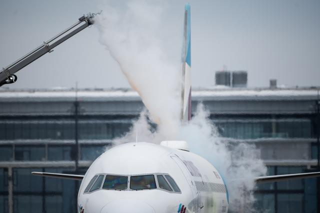 09 January 2026, Brandenburg, Schönefeld: A Eurowings aircraft is being de-iced on a de-icing area at Berlin-Brandenburg BER Airport. Photo: Christophe Gateau/dpa