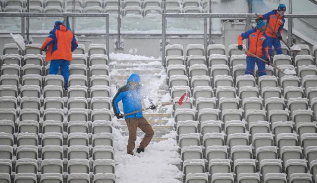 09 January 2026, Thuringia, Oberhof: Helpers shovel snow onto the stands in the biathlon stadium during the IBU Biathlon World Cup in Oberhof. Photo: Hendrik Schmidt/dpa