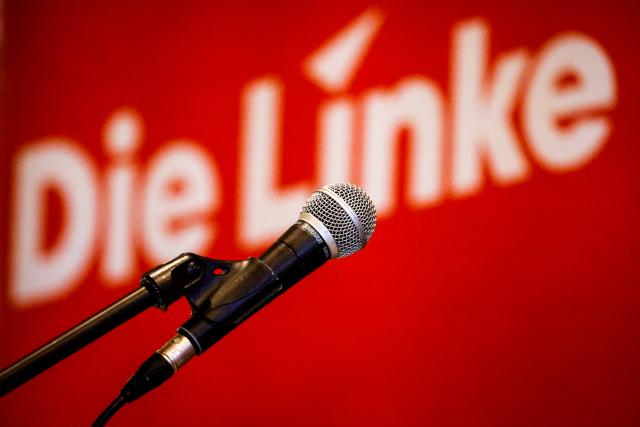 FILED - 21 June 2025, Bremen: A microphone stands in front of a party logo before the state party conference of Die Linke (The Left) in Bremen. Photo: Focke Strangmann/dpa
