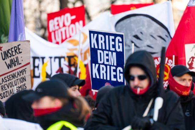 11 January 2026, Berlin: Participants hold banners and posters during the "Luxemburg-Liebknecht Tribute 2026" demonstration in memory of Rosa Luxemburg and Karl Liebknecht, who were murdered in 1919. Photo: Christophe Gateau/dpa