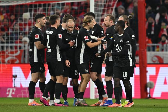 11 January 2026, Bavaria, Munich: VfL Wolfsburg's players celebrate their side's first goal scored by Dzenan Pejcinovic during the German Bundesliga soccer match between Bayern Munich and VfL Wolfsburg at Allianz Arena. Photo: Sven Hoppe/dpa