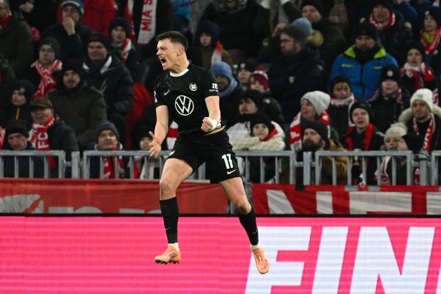 11 January 2026, Bavaria, Munich: VfL Wolfsburg's Dzenan Pejcinovic celebrates scoring his side's first goal during the German Bundesliga soccer match between Bayern Munich and VfL Wolfsburg at Allianz Arena. Photo: Sven Hoppe/dpa - IMPORTANT NOTICE: DFL and DFB regulations prohibit any use of photographs as image sequences and/or quasi-video.
