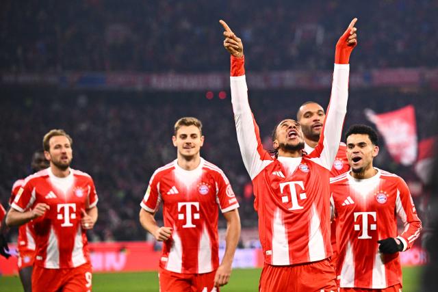 11 January 2026, Bavaria, Munich: Bayern Munich's Michael Olise celebrates scoring his side's third goal with his teammates during the German Bundesliga soccer match between Bayern Munich and VfL Wolfsburg at Allianz Arena. Photo: Tom Weller/dpa - IMPORTANT NOTICE: DFL and DFB regulations prohibit any use of photographs as image sequences and/or quasi-video.