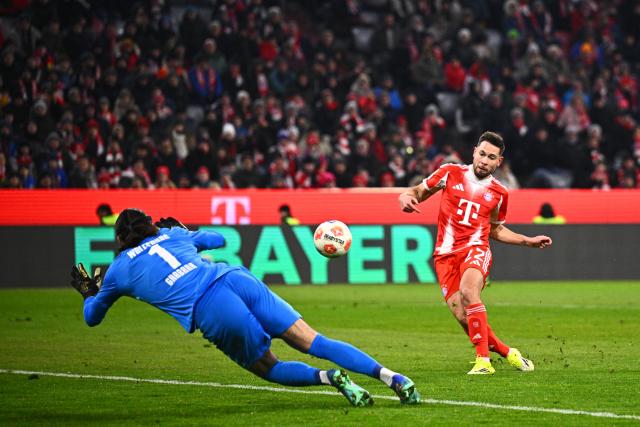 11 January 2026, Bavaria, Munich: Bayern Munich's Raphael Guerreiro scores his side's fifth goal during the German Bundesliga soccer match between Bayern Munich and VfL Wolfsburg at Allianz Arena. Photo: Tom Weller/dpa - IMPORTANT NOTICE: DFL and DFB regulations prohibit any use of photographs as image sequences and/or quasi-video.