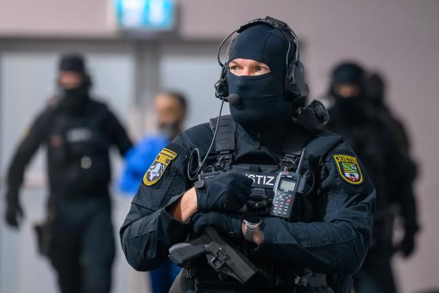 13 January 2026, Saxony-Anhalt, Magdeburg: Court officials lead defendant Taleb al-Abdulmohsen into the courtroom of the temporary Magdeburg Regional Court, where the trial continues against the driver accused of causing the fatal incident at the Magdeburg Christmas market. The Attorney General's Office accuses the Saudi national of 338 counts of attempted murder. Photo: Klaus-Dietmar Gabbert/dpa