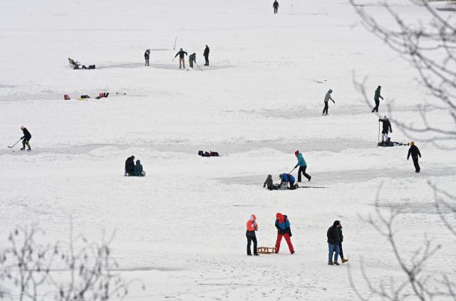 FILED - 05 January 2026, Bavaria, Spitzingsee: Tourists and locals frolic on the frozen Spitzingsee, which lies 1084 meters above sea level. Photo: Malin Wunderlich/dpa