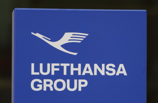 FILED - 23 December 2025, Hesse, Frankfurt/Main: A display with the new company logo stands in front of the Lufthansa Group headquarters, the Lufthansa Aviation Center. Photo: Andreas Arnold/dpa