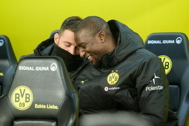 13 January 2026, North Rhine-Westphalia, Dortmund: Borussia Dortmund's Salih Oezcan (L) and Serhou Guirassy sit on the bench during the German Bundesliga soccer match between Borussia Dortmund and Werder Bremen at Signal Iduna Park. Photo: Bernd Thissen/dpa - IMPORTANT NOTE: In accordance with the regulations of the DFL German Football League and the DFB German Football Association, it is prohibited to utilize or have utilized photographs taken in the stadium and/or of the match in the form of sequential images and/or video-like photo series.
