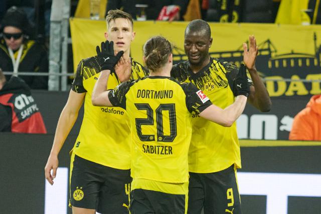 13 January 2026, North Rhine-Westphalia, Dortmund: Borussia Dortmund's Serhou Guirassy (R) celebrates scoring his side's third goal with teammates Nico Schlotterbeck (L) and Marcel Sabitzer during the German Bundesliga soccer match between Borussia Dortmund and Werder Bremen at Signal Iduna Park. Photo: Bernd Thissen/dpa - IMPORTANT NOTE: In accordance with the regulations of the DFL German Football League and the DFB German Football Association, it is prohibited to utilize or have utilized photographs taken in the stadium and/or of the match in the form of sequential images and/or video-like photo series.