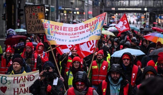 14 January 2026, Berlin: Participants display flags at a trade union demonstration for employees covered by the collective agreement for the states of Berlin and Brandenburg. Those affected include staff at schools, universities, daycare centers, police, fire departments, and state authorities. A second round of negotiations is scheduled for January 15-16 in Potsdam. Photo: Britta Pedersen/dpa