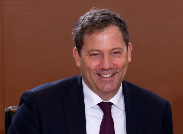 14 January 2026, Berlin: Lars Klingbeil, Germany's Finance Minister, sits at the table in the Chancellery laughing before the start of the cabinet meeting. Photo: Soeren Stache/dpa
