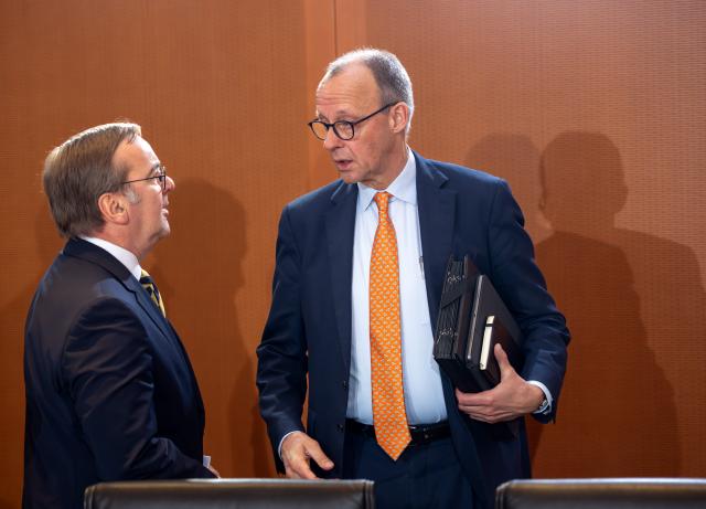 14 January 2026, Berlin: Germany's Chancellor Friedrich Merz (R) and Defence Minister Boris Pistorius (L) speak in the Chancellery ahead of the start of a cabinet meeting. Photo: Soeren Stache/dpa