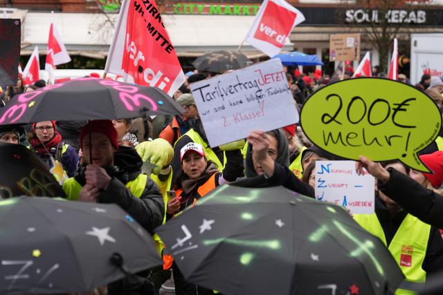 14 January 2026, Hamburg: Participants demonstrate during a warning strike in the public sector on the station forecourt in Bergedorf. The trade union Verdi has called on public sector employees in the federal states to go on a warning strike. Photo: Marcus Brandt/dpa