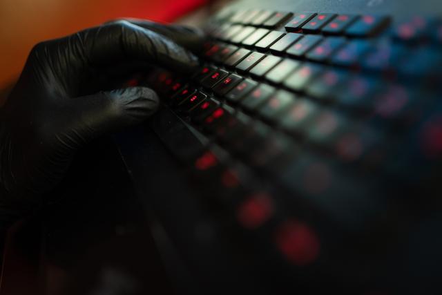 FILED - 29 April 2020, Bavaria, Ebing: A man wearing gloves types on a computer keyboard. Law enforcement agencies in Germany, the US and the United Kingdom have dismantled the global cybercrime subscription service RedVDS that enabled users to commit widespread online fraud, German authorities said on Wednesday. Photo: Nicolas Armer/dpa