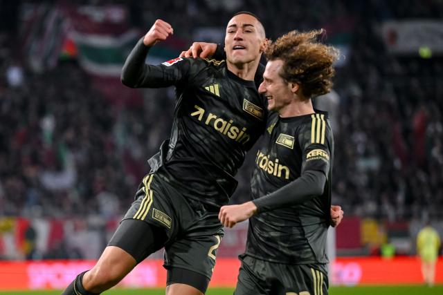 15 January 2026, Bavaria, Augsburg: Union Berlin's Marin Ljubicic celebrates scoring his side's first goal with his teammate Alex Kral during the German Bundesliga soccer match between FC Augsburg and 1. FC Union Berlin at WWK-Arena. Photo: Harry Langer/dpa - IMPORTANT NOTE: In accordance with the regulations of the DFL German Football League and the DFB German Football Association, it is prohibited to utilize or have utilized photographs taken in the stadium and/or of the match in the form of sequential images and/or video-like photo series.