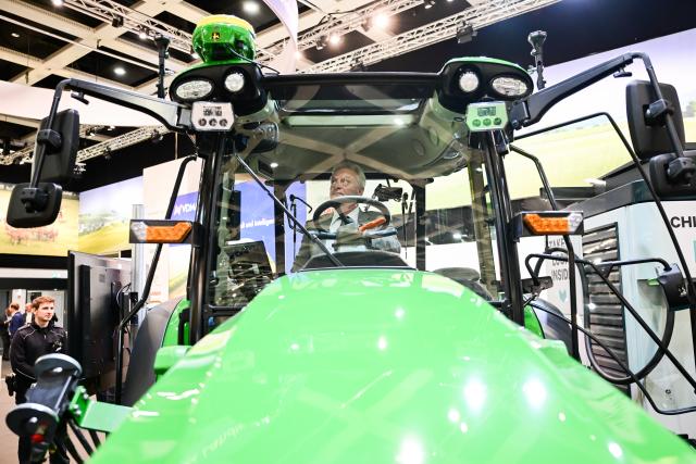 16 January 2026, Berlin: Alois Rainer, Germany's Minister of Food, Agriculture, and Rural Affairs, sits in a John Deere electric tractor during the opening tour at the start of the 90th International Green Week. Photo: Sebastian Christoph Gollnow/dpa