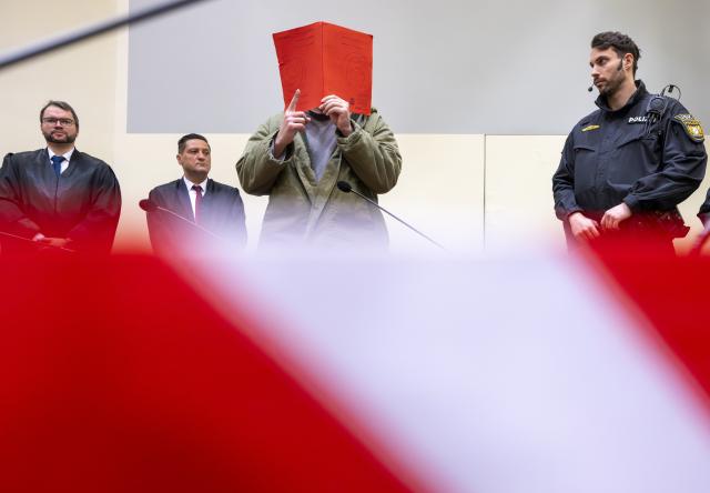 16 January 2026, Bavaria, Munich: The defendant Farhad N. stands in the courtroom at the start of his trial on charges of double murder following a car attack on a demonstration in Munich on February 13, 2025. Photo: Peter Kneffel/dpa