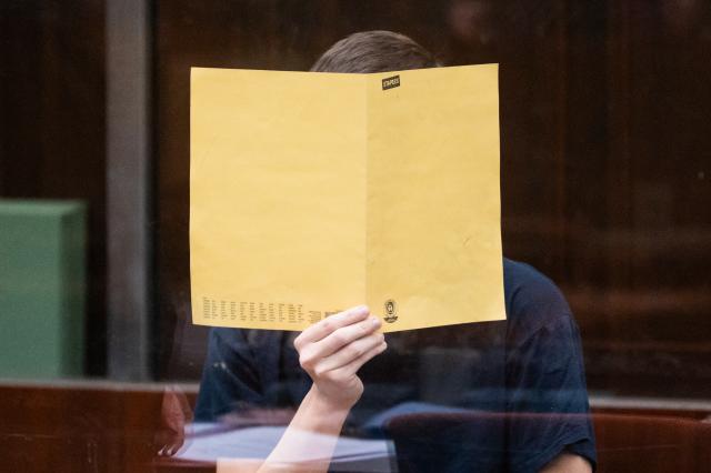FILED - 01 December 2025, Berlin: The accused, a suspected IS supporter, sits behind a pane of glass in the courtroom at the start of his trial.  A 19-year-old man was on Friday sentenced in Berlin to three years in juvenile detention for preparing a serious attack in Germany, attempting to join the Islamic State (IS) extremist militia and other offences. Photo: Christophe Gateau/dpa