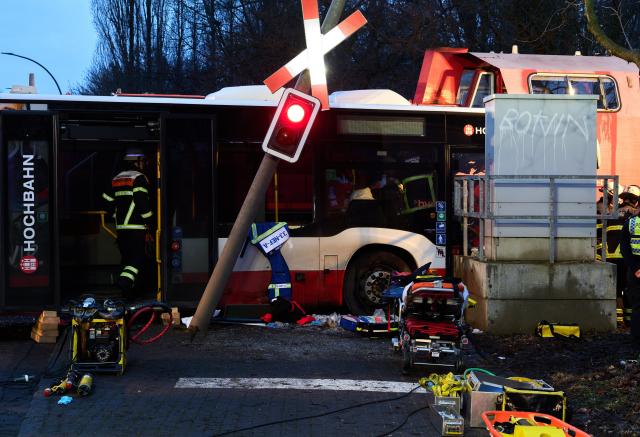 16 January 2026, Hamburg: Emergency services are on duty after a bus collided with a train in Hamburg. According to the fire department, one person died and at least ten others were injured. Photo: Marcus Golejewski/dpa