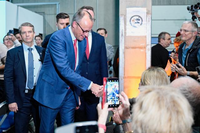 16 January 2026, Baden-Württemberg, Heddesheim: German Chancellor Friedrich Merz (2nd L) shakes hands with an attendee during an election campaign event of the Christian Democratic Union at the Pfenning Logistics forwarding company in Heddesheim. Photo: Uwe Anspach/dpa