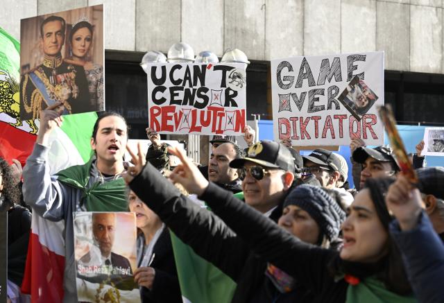 17 January 2026, North Rhine-Westphalia, Cologne: Participants hold signs and flags during a demonstration in Cologne in support of the protests in Iran. Photo: Roberto Pfeil/dpa