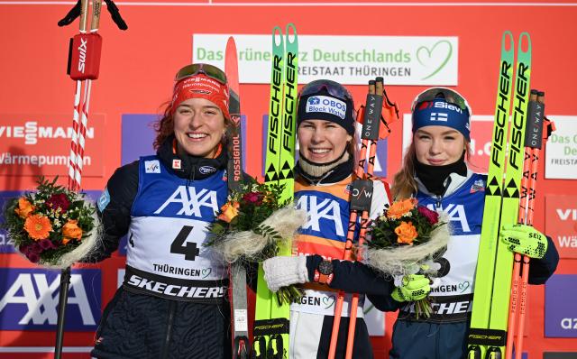 17 January 2026, Thuringia, Oberhof: Norway's winner Ida Marie Hagen (C), Germany's runner up Nathalie Armbruster (L) and Finland's third placed Minja Korhonen celebrate on the podium the Women's individual compact normal hill event of the FIS Nordic Combined World Cup in Oberhof. Photo: Hendrik Schmidt/dpa
